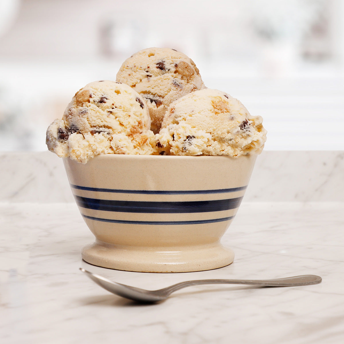 Bowl of Blue Bell Brookie A La Mode Ice Cream with a spoon