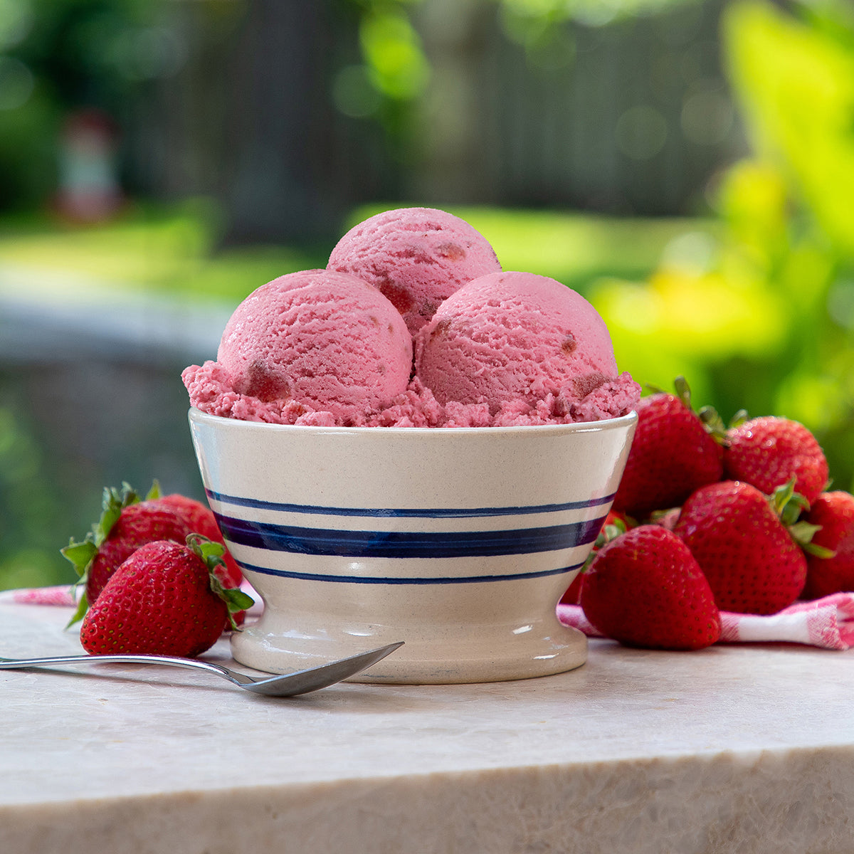 Blue Bell Strawberry Ice Cream in bowl with strawberries
